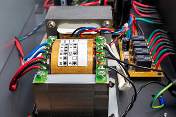 Electric power transformer in amplifier, inductor transformer coil with power cable, close-up