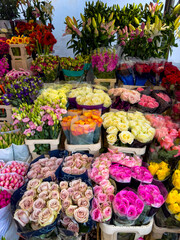 rich assortment of roses, lilies, and seasonal flowers in city market. flower shop. floral background. multicolored wallpaper with assorted flower