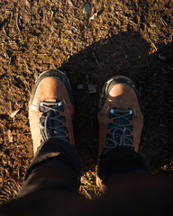 Hiker wearing trekking boots standing on dirt trail in aiaraldea, basque country