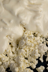 sprinkled with liquid sour cream, lumps of freshly made fermented milk product, side view