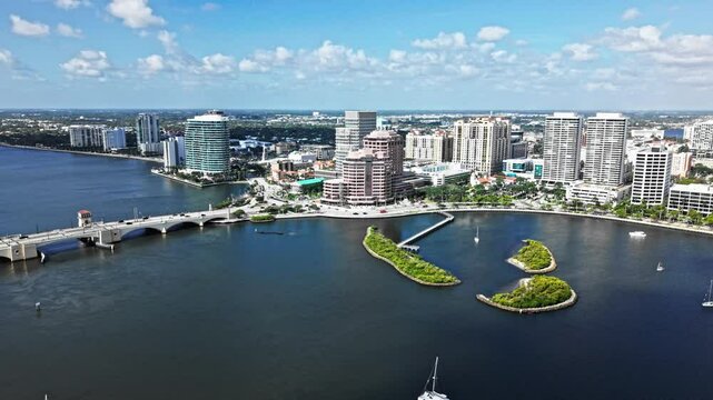 Aerial: One Flagler, Phillips Point Building and West Palm Beach cityscape during the day in Florida, USA, orbit drone shot