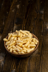 a large number of corn sticks for eating or making breakfast with milk, corn sticks in a wooden bowl, closeup