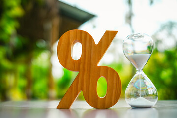Percentage symbol and hourglass, concept of tax and loan interest, deposit interest, income or...