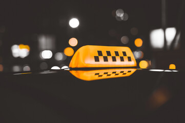 Close-up sign Lanterns taxi checker. Night city street background.