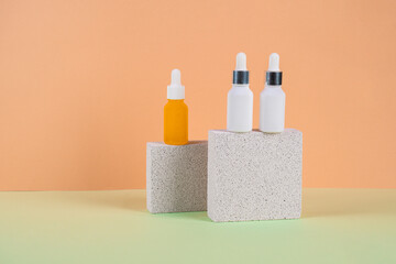 Cosmetic product in tube, bottle, lotion or serum with stylish props on cream background. 