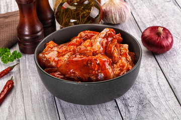 Raw marinated buffalo chicken wings