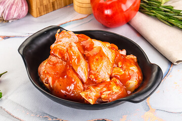 Raw marinated uncooked chicken wings