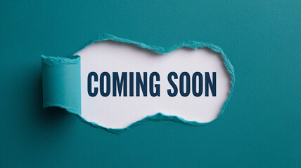 Torn teal paper reveals white space with "Coming Soon" text, signifying anticipation and upcoming events, ideal for announcements or marketing