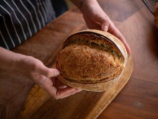 Artisan Sourdough Bread in Hand – Fresh from the Oven.