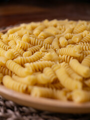 Raw Fusilli Spiral spaghetti pasta pattern background.