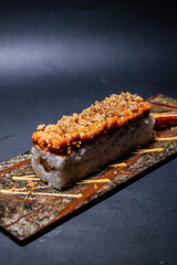 Hot sight roll sushi, served on a stone slate, Japanese food, maki, nori, fine dining restaurant photography, social media post, banner, flyer, dark background