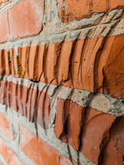 A close up of a brick wall with cracks in it