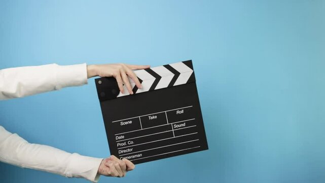 Studio scene setup, clapping the slate, marking a film take during shooting