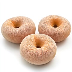 Delicious looking three cantaloupe melon donuts isolated on white background sweet dessert food photography