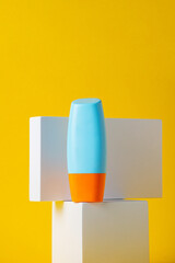 Blank tube with cosmetic product for moisturizing on yellow background