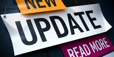 Close-up of white banner with black "UPDATE" text, accompanied by smaller orange and purple banners reading "NEW" and "READ MORE", suggesting a website or app update announcement