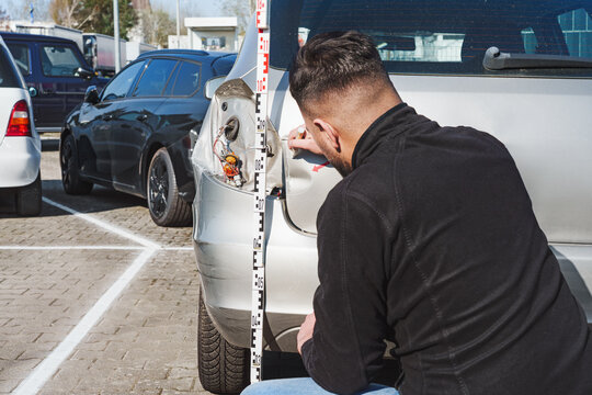  Appraiser inspects a car with accident damage - vehicle appraiser