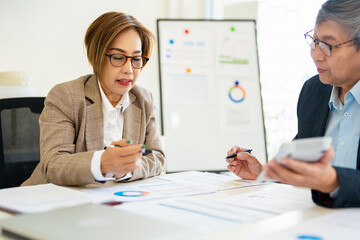 Meeting a team of businessmen, Executives and accountants meeting about the company's revenue graph in the office with laptops and calculator, Finance concept.