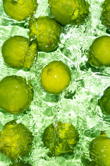Green Limes on Water Surface Flat Lay Vertical
