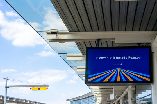 Mississauga, Ontario, Canada - May 7, 2025: A &ldquo;welcome to Toronto Pearson&rdquo; sign in French at the passenger drop-off area in Pearson International Airport in Mississauga, Ontario, Canada.