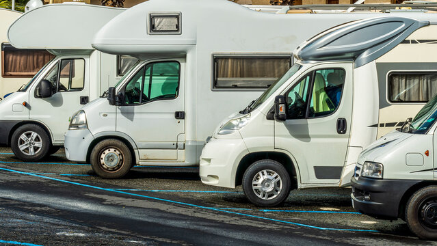 campers and motorhomes on asphatl parning, white auto caravan for  vacation travel