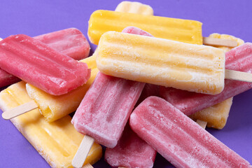 Red strawberry popsicles and yellow popsicles
