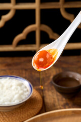 Salted duck eggs, a type of hand-pickled egg, are placed on a wooden table indoors