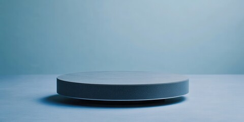 Empty circular grey platform on a muted blue background
