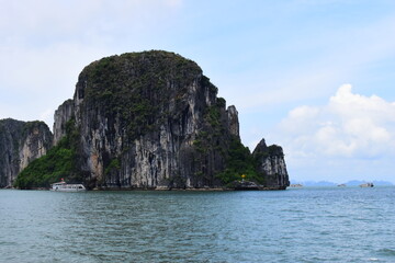 Fototapeta premium HA LONG BAY, VIETNAM - JULY 19, 2022: Beautiful view of the Halong bay, Vietnam. UNESCO World Heritage. This was on a cloudy day, with many boats and spells of sunshine. during the Covid 19 pandemic. 