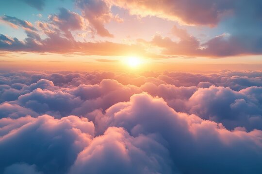 Beautiful sunrise view above clouds at dawn with soft pastel colors in the sky