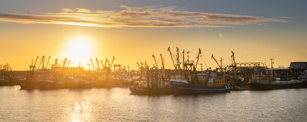 Sunset landscape of Dutch harbor Lauwersoog with fishing ships long the Waddensea in Groningen the Netherlands