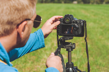 Professional Photographer takes pictures on the background of the landscape.