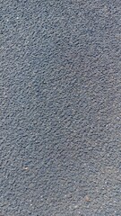 Close-up view of dark gray sands, showing its coarse texture and granular composition. Ideal for background or overlay.