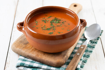 Traditional Spanish Gazpacho soup in bowl on white wooden table