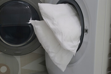White pillow in washing machine.