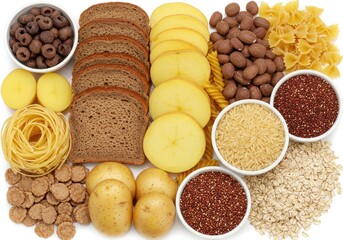 Selection of carbohydrate rich foods including pasta, bread, potatoes and grains