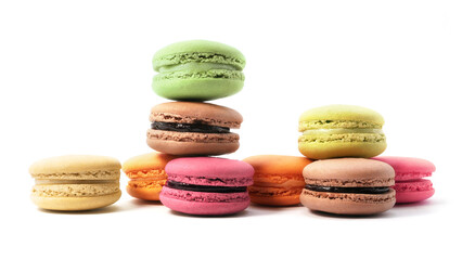 Pile of macaron cookies in various flavours and colours isolated on white background.