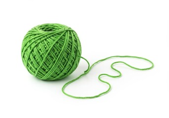 A single ball of green yarn with a loose strand on a white background in a studio setting