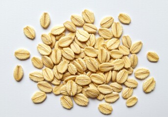 Obraz premium Rolled oats scattered on a white surface, showing texture and shape of the healthy breakfast ingredient