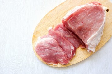Fresh pork loin in cutting board on white background