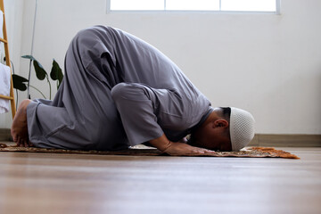 Adult Muslim Man Wear Skullcap Praying Salah In Sujood Or Prostration Posture
