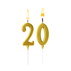 Burning golden cake candles composing number 20 on white background. Festive decoration for...