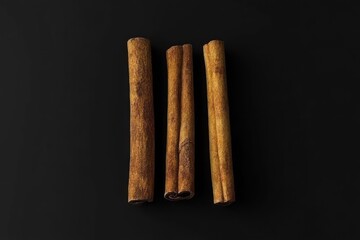 Three cinnamon sticks on black background