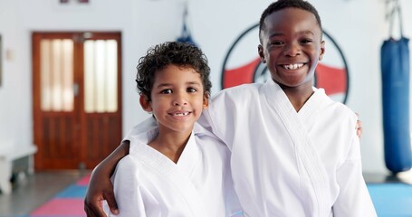 Hug, karate and portrait of friends in class for martial arts, self defense or sports training. Development, fitness and smile of student kids embracing in dojo together for exercise or workout © CineLens25/peopleimages.com