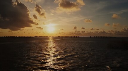 A breathtaking drone capture of the Sunshine Skyway Bridge, its iconic silhouette stretching across Tampa Bay, with sunlit waves below and a vivid sky above.  