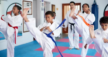 Fototapete Rund Kampfkunst Exercise, karate and sports with kids in class for combat, fighting or self defense training. Development, fitness or growth with children and sensei in dojo for martial arts lesson or practice  © peopleimages.com