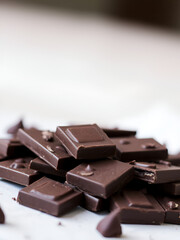 Close-up of a pile of dark chocolate pieces.