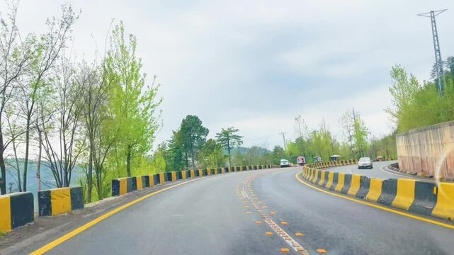Pakistan murre road and  Asphalt road in World, Alps in a beautiful summer day, Hochalpenstrasse, Driving car on a mountain road. Ahead is a green forest and mountain nature landscape in summer.
