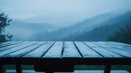 Misty Mountain View from Wet Wooden Picnic Table Top Perspective in Atmospheric Blue Haze Landscape