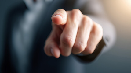 Naklejka premium Close-up of a businessman’s hand pointing forward as if touching a virtual screen, symbolizing leadership, decision-making, and digital interaction. 